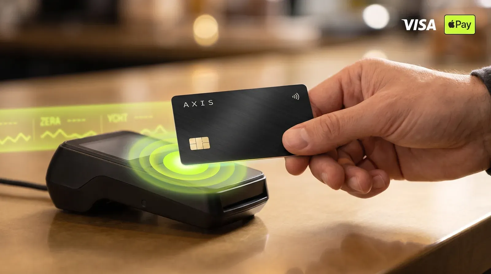 The card tapped on a contactless terminal — Visa and Apple Pay.